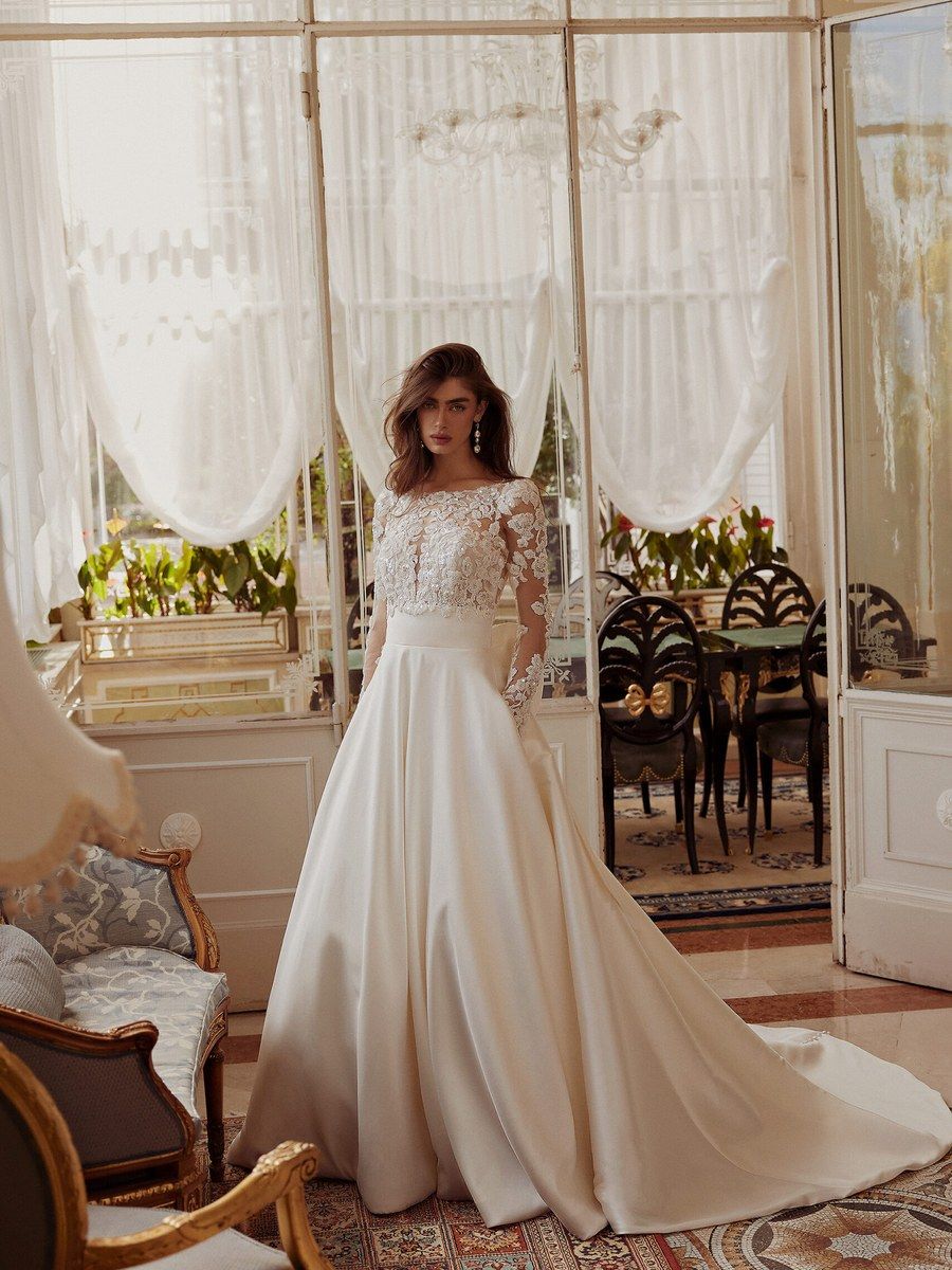 Lace-sleeve bridal gown in a chandelier salon